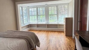 A bedroom with a large bay window, a bed, a desk, and a wardrobe. - University Hill Entire 5 BR House -  Walk to SU campus, Upstate Hospital (Syracuse)
