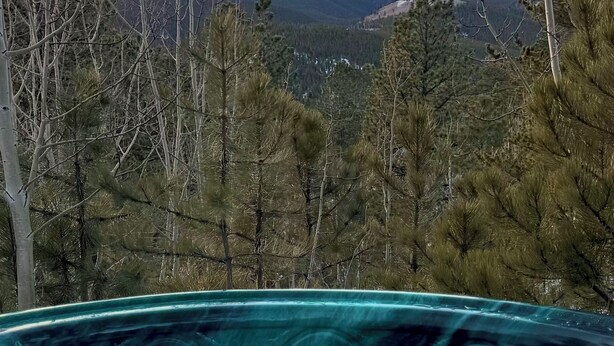 A hot tub with a view of a mountainous landscape. - Quiet Moose Cabin: 2-bedroom cabin, Mountain views, Hot tub for cozy getaway (Bailey)