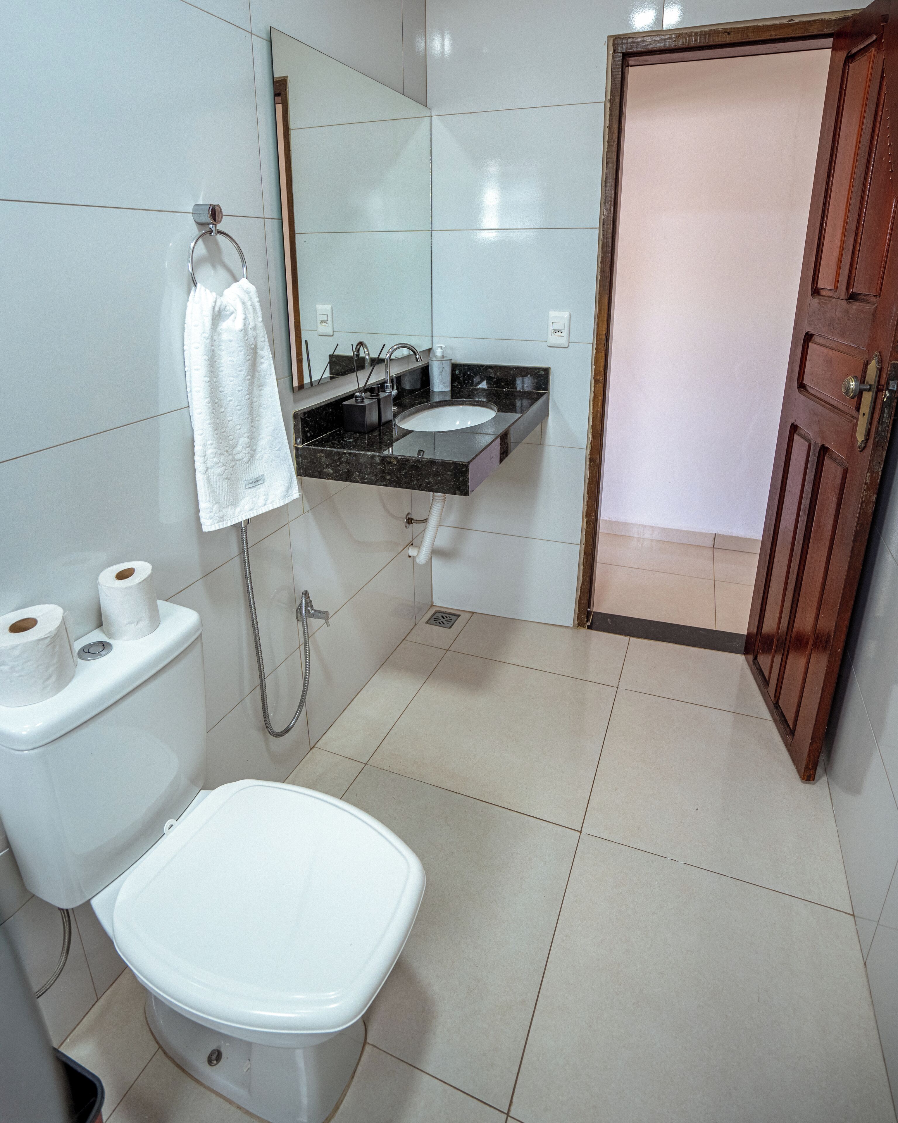 A bathroom with a toilet, sink, and shower.