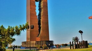 A tall, rectangular building with a vertical crack running down its center.
