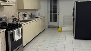 A kitchen with a stove, microwave, and refrigerator.