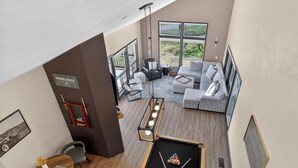 A pool hall with a billiards table, a sofa, and a dining area with a table and chairs. - Golf villa located in Continental Country Club (Flagstaff)