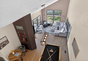 A pool hall with a billiards table, a sofa, and a dining area with a table and chairs. - Golf villa located in Continental Country Club (Flagstaff)