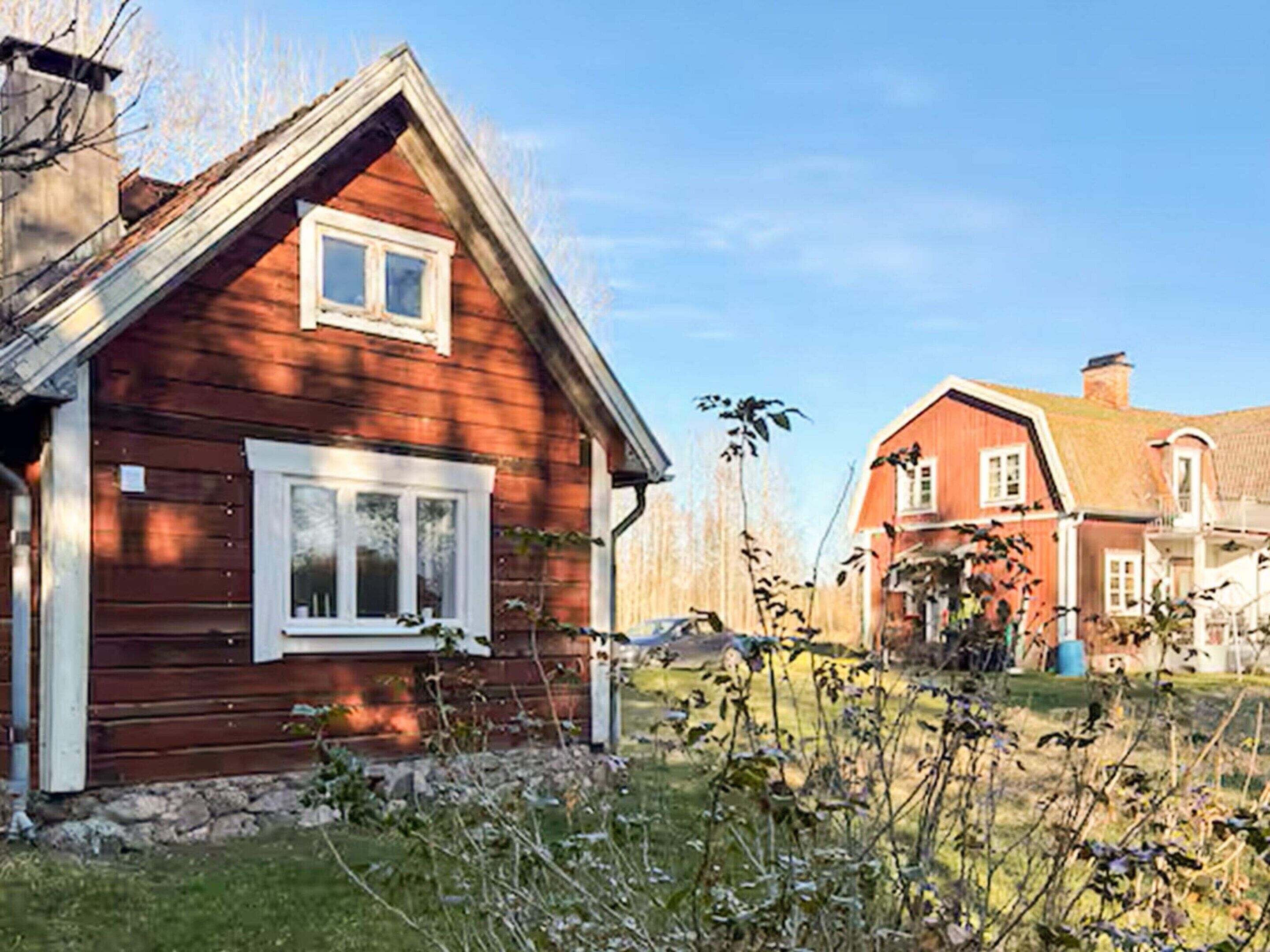 A wooden house with a gabled roof and a small window.