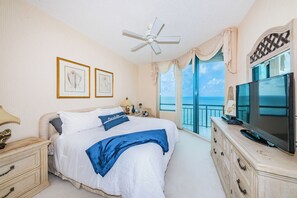 A bedroom with a bed, a television, a dresser, a nightstand, and a ceiling fan. - WHITE SANDS BEACHFRONT SUNSET SUNRISE LUX EVERY ROOM SEA POOLS SPAS IN/OUT (Clearwater)