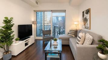 Economy Suite, 1 Bedroom | Living area | 50-inch flat-screen TV with digital channels