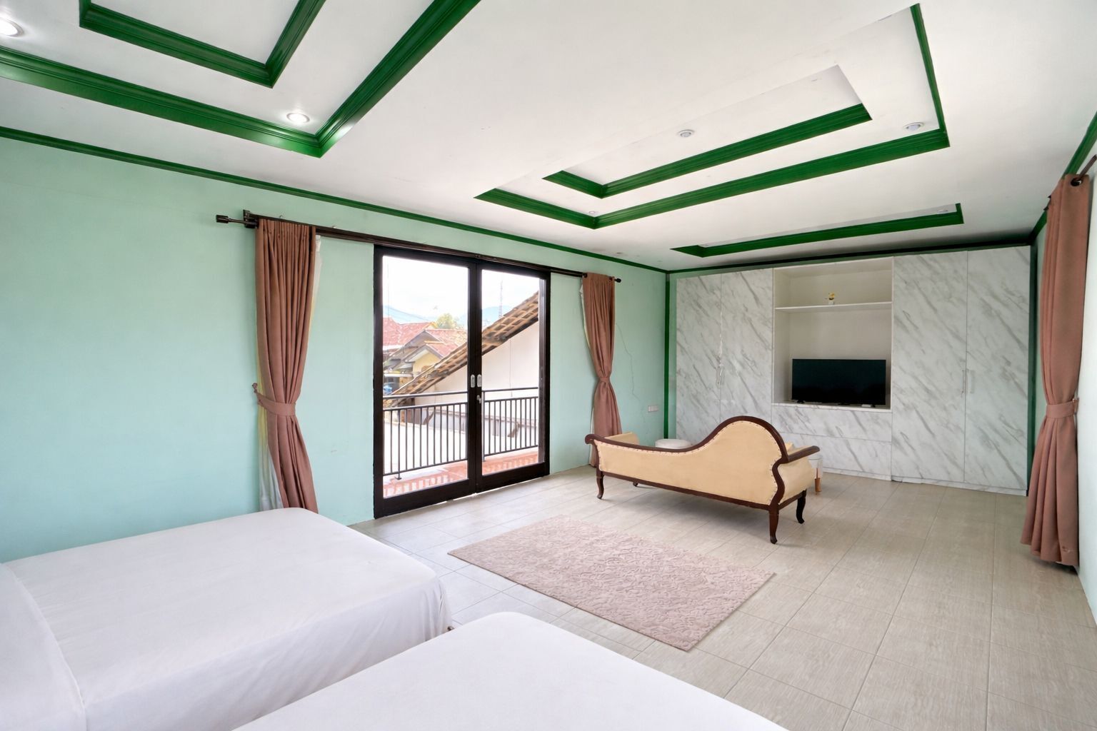 A room with a bed, a sofa, a chaise lounge, a TV, and a balcony with a view.