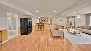 A spacious living area with a kitchen, a sofa, and a dining table.