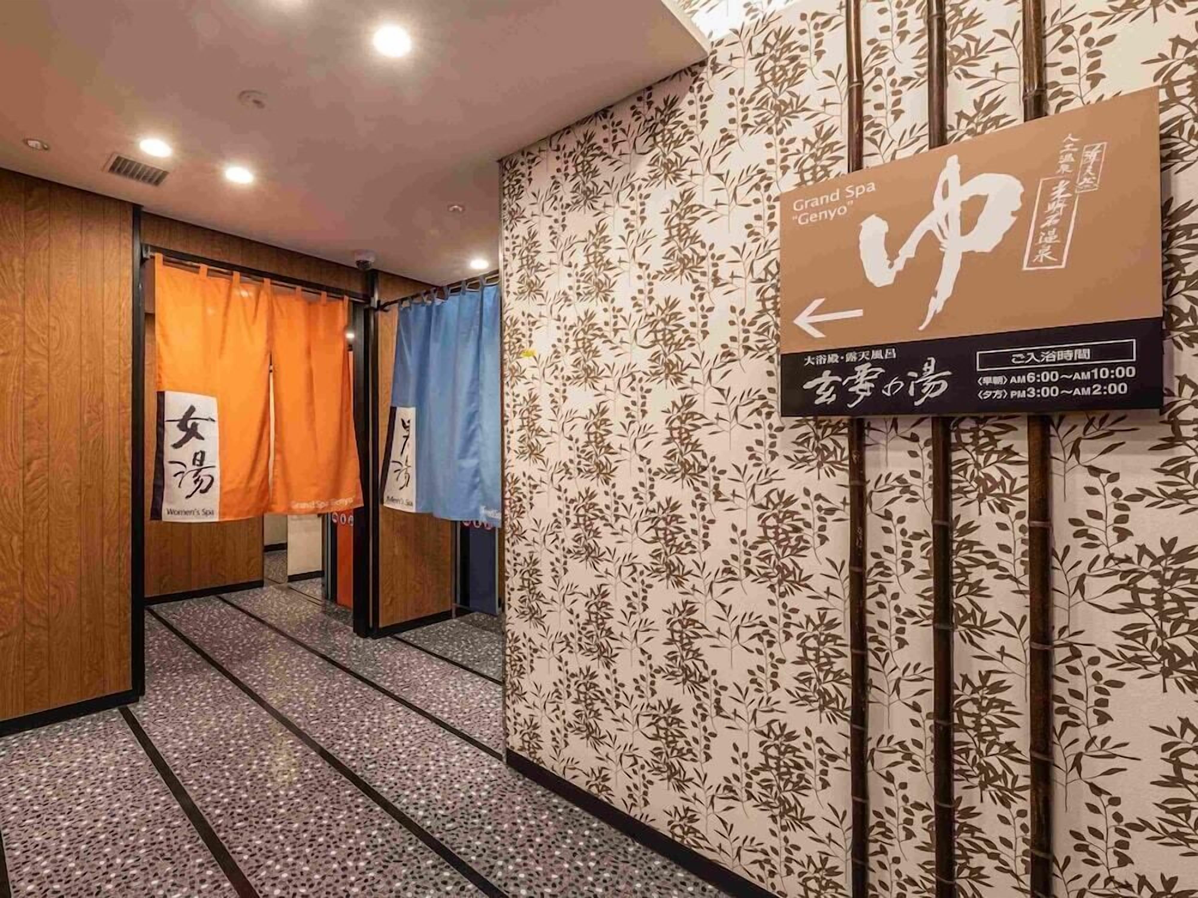 A hallway with a sign indicating the Grand Spa 'Genyo' and a women's spa.