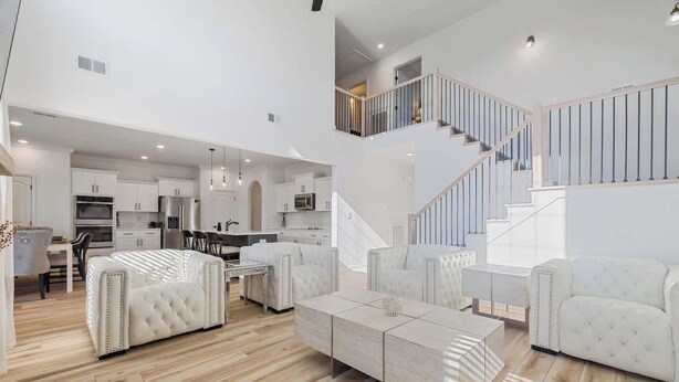 A spacious living area with a staircase, a dining area, and a kitchen. - Fort Haven Near Fort Campbell, Spacious 4BR Retreat (Clarksville)