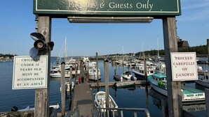 A marina sign with 'Welcome To Dysart's Great Harbor Marina' and 'Guests Only' text.
