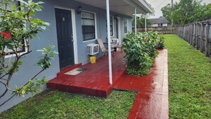 A residential house with a porch, a door, and a window. - Furnished 2BR - Ideal for Relocation & Extended Stays (Fort Lauderdale)