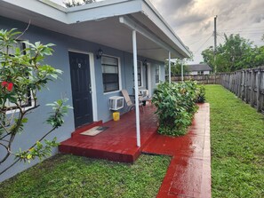 A residential house with a porch, a door, and a window. - Furnished 2BR - Ideal for Relocation & Extended Stays (Fort Lauderdale)