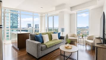 Family Suite, 2 Bedrooms, City View | Living area | 50-inch flat-screen TV with digital channels