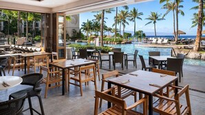 A poolside restaurant with outdoor seating, a view of the ocean, and palm trees. - WESTIN NANEA OCEAN VILLAS 2 BDRM Resort View Maui, Lahaina
May 29 – June 1, 2026 (Lahaina)