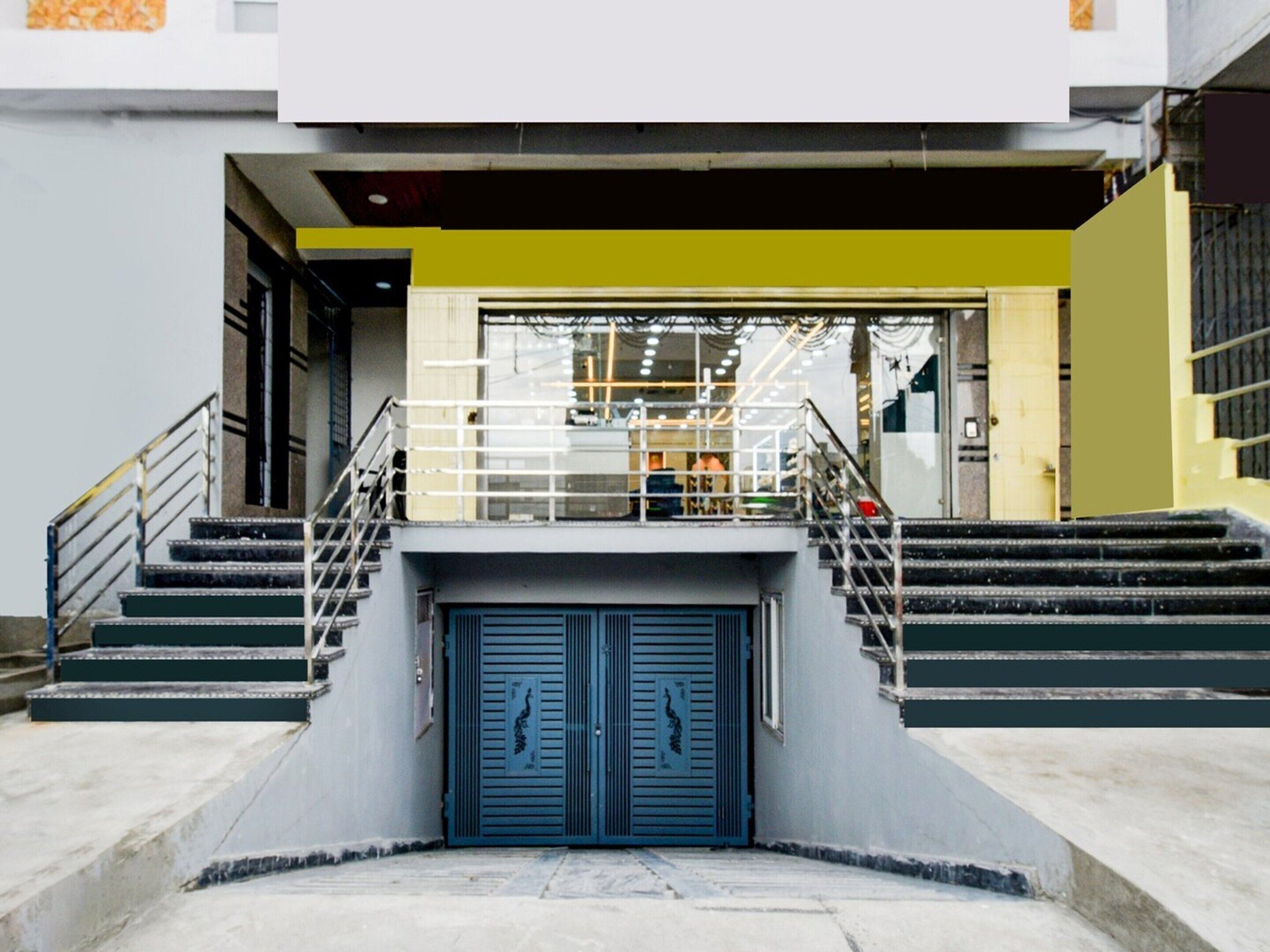 A building entrance with a double door, a staircase, and a railing.
