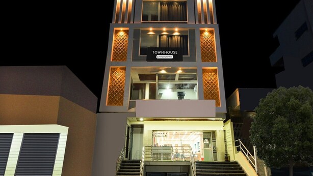 A multi-story building with a sign reading 'TOURNHOUSE Company-Serviced' at the entrance. - Townhouse Badangpet Crossway Hyderabad (Hyderabad)