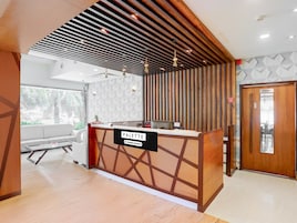 A reception desk with a sign reading 'PALETTE & Company-Serviced,' wooden slats on the ceiling, a sofa, and a door labeled 'RESTAURANT.'