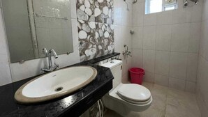 A bathroom with a sink, toilet, and shower. - Collection O Gummidipundi Bus Terminal (Gummidipundi)