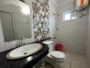 A bathroom with a sink, toilet, and shower.