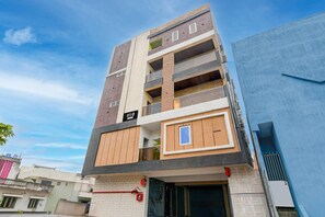 A multi-story hotel with a modern design, featuring balconies and a prominent entrance. - Deluxe Siva Karthikeya Residency (Parvathipuram)