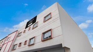 A building with a sign reading 'Collation,' multiple windows, and a closed shutter. - Premium Collection O Joka Industrial Plaza (Alipur)