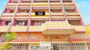 A multi-story hotel with a prominent 'HOTEL' sign, balconies, and a tiled facade. - Hotel O Gajuwaka Near Kurmanpalem (Visakhapatnam)