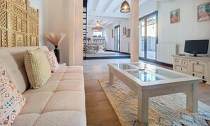 A modern living room with a sofa, coffee table, and decorative items. - Cosy house with swimming pool, a trip to Gascony! (Montréal)