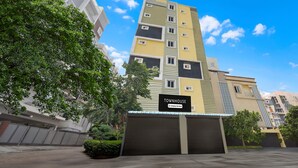 A multi-story building with a sign reading 'TOWNHOUSE Company Services.' - Deluxe Rks Prestige (Hyderabad)