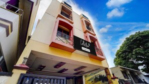 A multi-story building with a prominent sign reading 'Collection & Company Limited.' - Premium Hotel Apple Grand (Coimbatore)