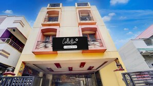 A building with a sign that reads 'Collection Company Serviced.' - Premium Hotel Apple Grand (Coimbatore)