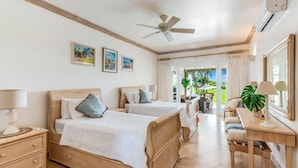 A hotel room with two beds, a desk, a chair, a ceiling fan, and a view of the outdoors. - Sugar Hill Birds Eye Villa - by ZenBreak (Mount Standfast)