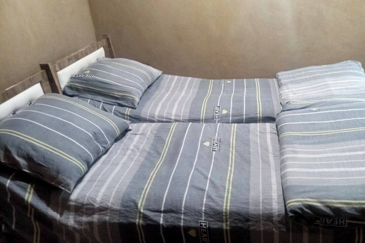 A bed with striped bedding and pillows.