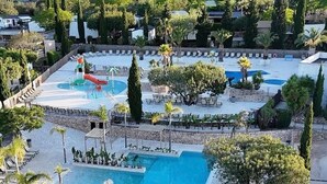 Een resort met een zwembad, ligbedden en een glijbaan.