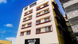 A multi-story hotel building with a sign indicating it is company-serviced. - Suite Marquis Street BK International (Kolkata)
