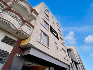 A multi-story building with a sign reading 'TOWNHOUSE.'