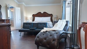 A bedroom with a large bed, a sofa, an ottoman, a ceiling fan, and a large mirror. - 3-Bdrm, 2.5-Bth WaterFront View Home (Katy)