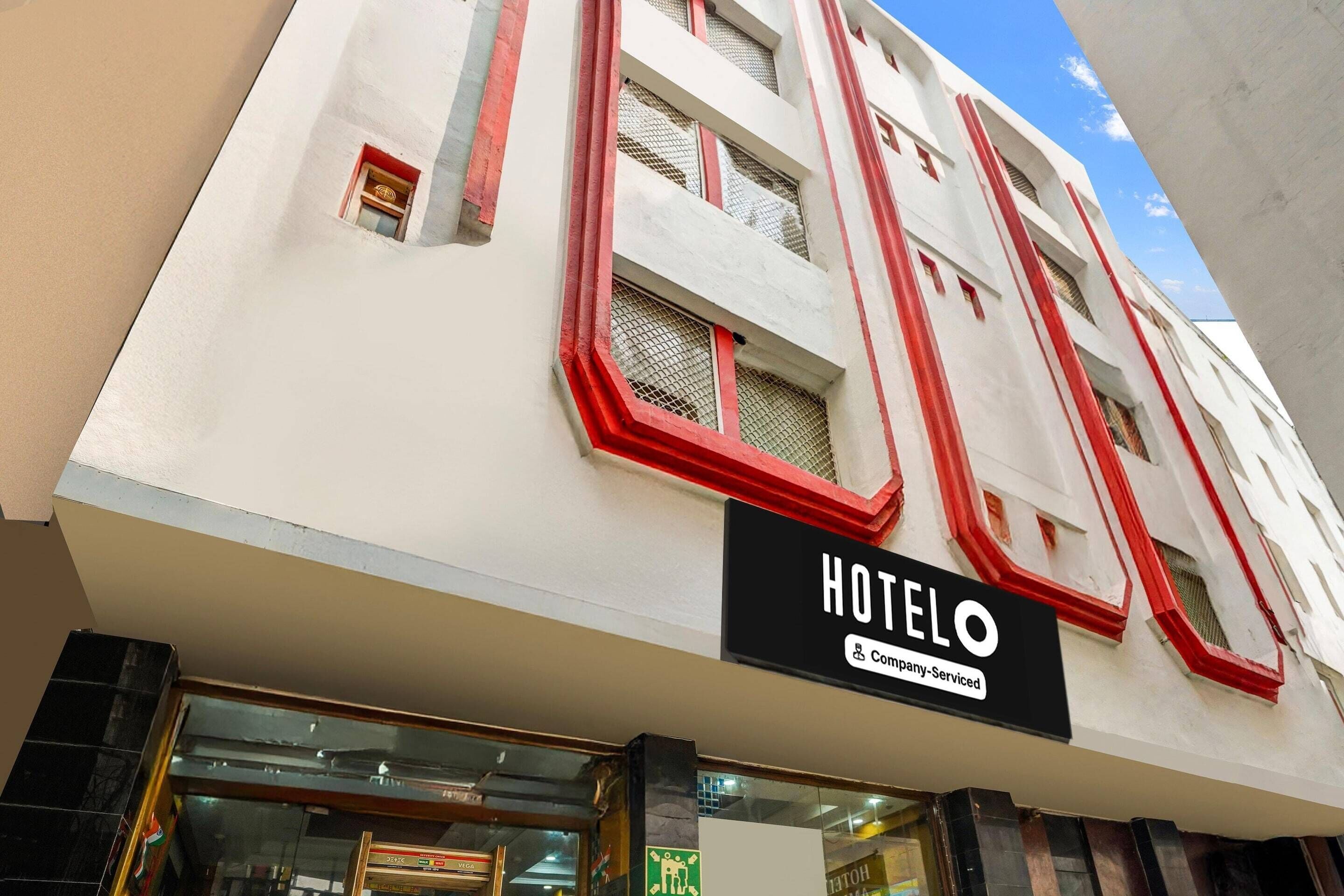 A hotel building with a sign that reads 'HOTEL ELO' and a company-serviced symbol.