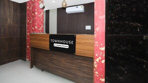 A reception desk with a sign reading 'TOWNHOUSE Company-Serviced.'