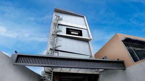 A modern building with a sign reading 'TOWNHOUSE' and a spiral staircase.