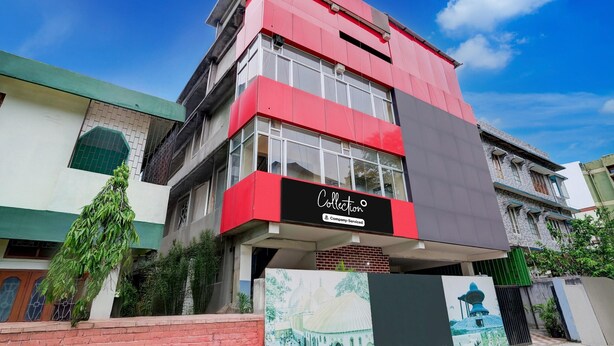 A multi-story building with a prominent red facade, a sign reading 'Collection,' and a mural of a traditional building. - Saver Double Last Gate Near Dispur Law College (Guwahati)