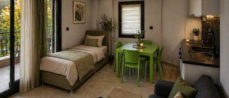 Un apartamento moderno con cama, mesa de comedor, sofá y zona de cocina.
