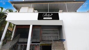 A modern building with a sign reading 'Collection' and a 'Pathology Clinic' sign below the entrance. - Deluxe Khusboo Palace (Lucknow)