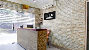 A reception desk with a 'HOTEL O' sign, a computer, and a telephone. - Deluxe Shibpur Tram Depot Samrat Palace (Howrah)