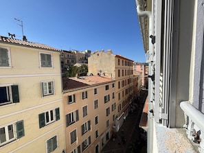 A narrow street with buildings on either side, featuring balconies and windows. - Central studio, AC - 2 guests (Ajaccio)