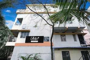 A multi-story building with a sign that reads 'Collection Company-Serviced.'
