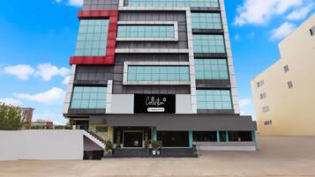 A modern building with a sign reading 'Collection Company-Serviced.'