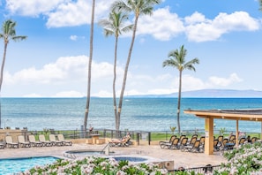 A poolside area with lounge chairs, a hot tub, and a view of the ocean. - SUMMER SALE! 1BD, 1BR Ocean-view getaway- Sugar Beach 215 (Kihei)