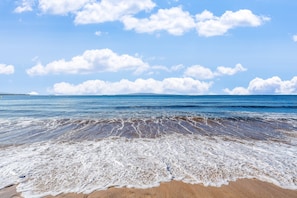 A beach with waves, a clear sky, and distant land. - SUMMER SALE! 1BD, 1BR Ocean-view getaway- Sugar Beach 215 (Kihei)