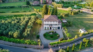 A large, two-story house with a symmetrical facade, a central entrance, and a well-maintained garden. - Villa Near Lucca With Tuscan Garden Views (Capannori)
